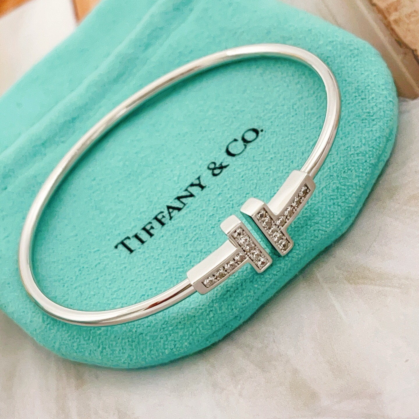 Tiffany Co T Wire bracelet Sterling silver metal with clear diamond accents also available in 18k yellow gold and 18k rose gold metal with clear diamond accents 17cm inner circumference