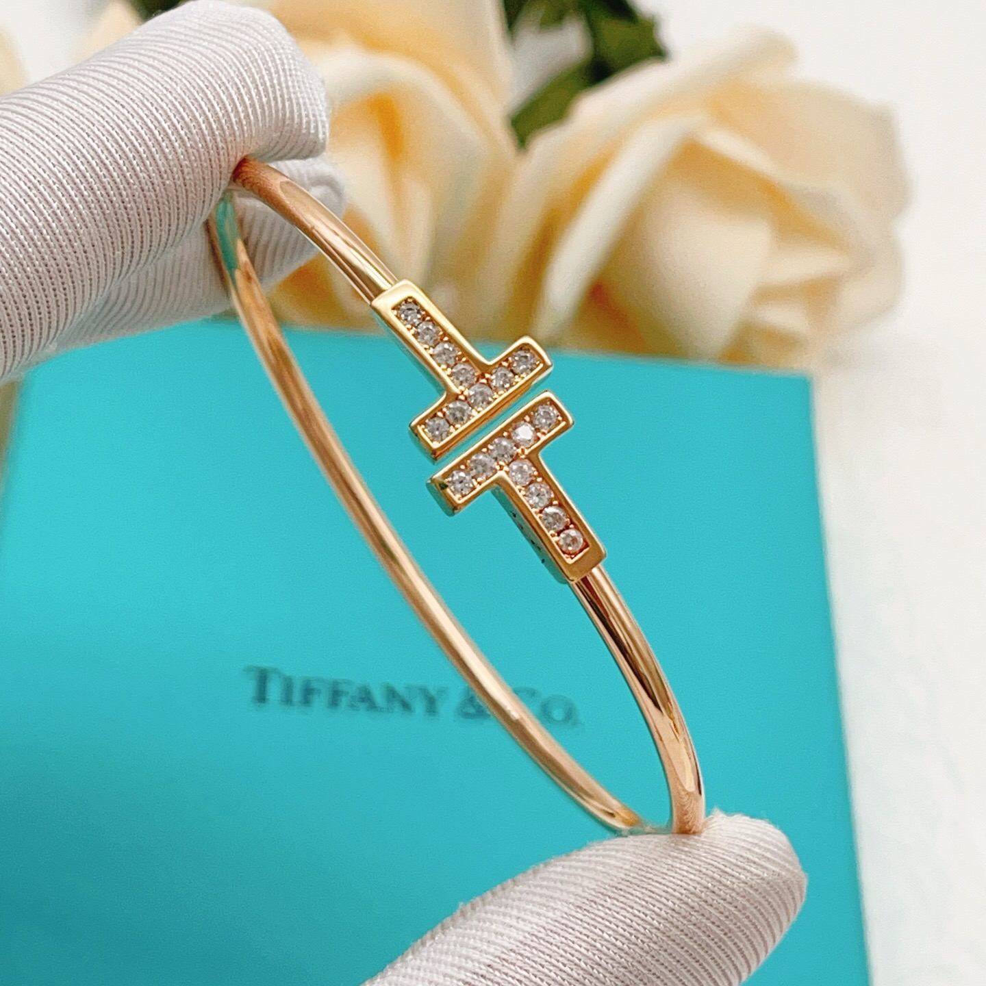 Tiffany T Wire bracelet 18k rose gold with clear diamond accents 18k yellow gold with clear diamond accents sterling silver with clear diamond accents 17cm inner circumference