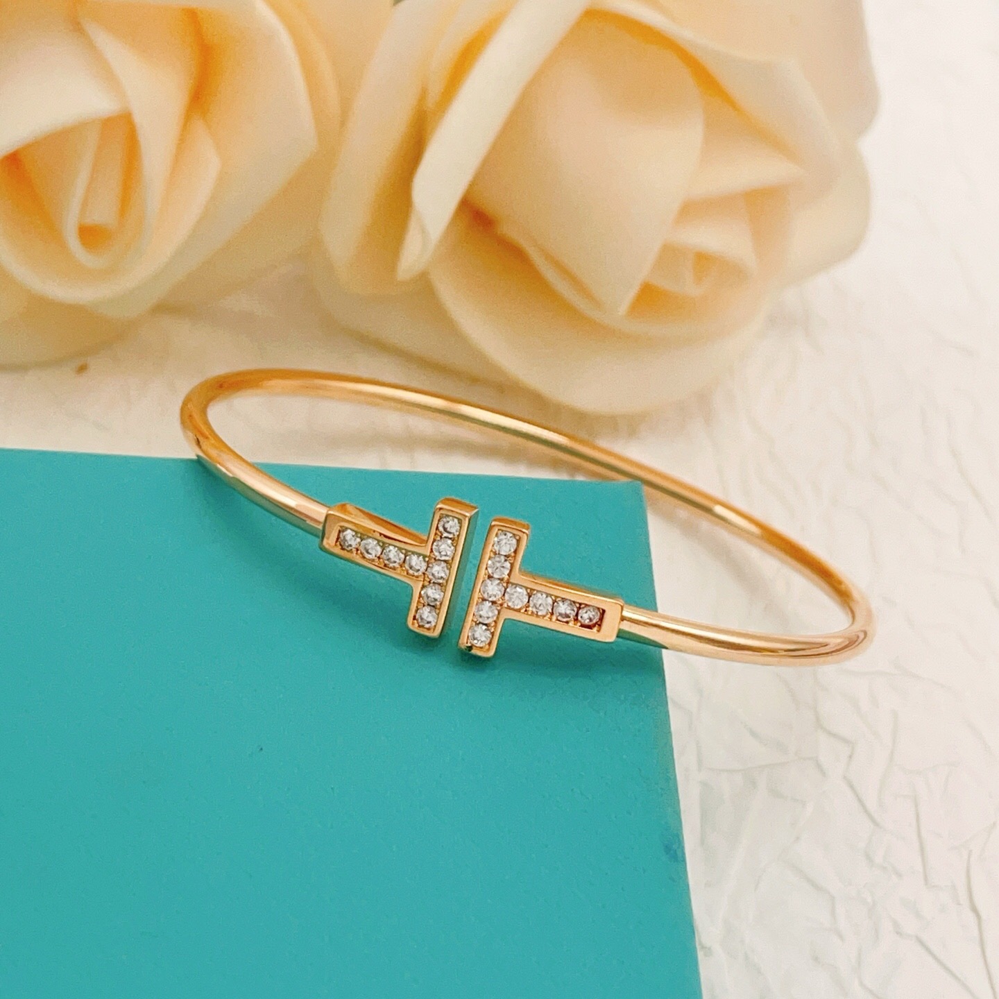Tiffany T Wire bracelet 18k rose gold with clear diamond accents 18k yellow gold with clear diamond accents sterling silver with clear diamond accents 17cm inner circumference