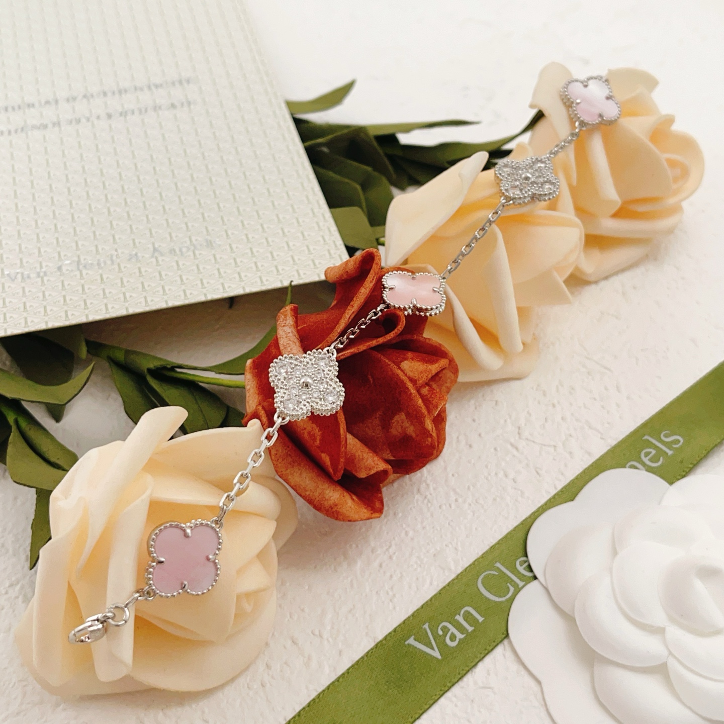 Van Cleef Arpels Alhambra bracelet Silver-toned white gold metal with pink mother-of-pearl white mother-of-pearl and clear diamond accents 17cm
