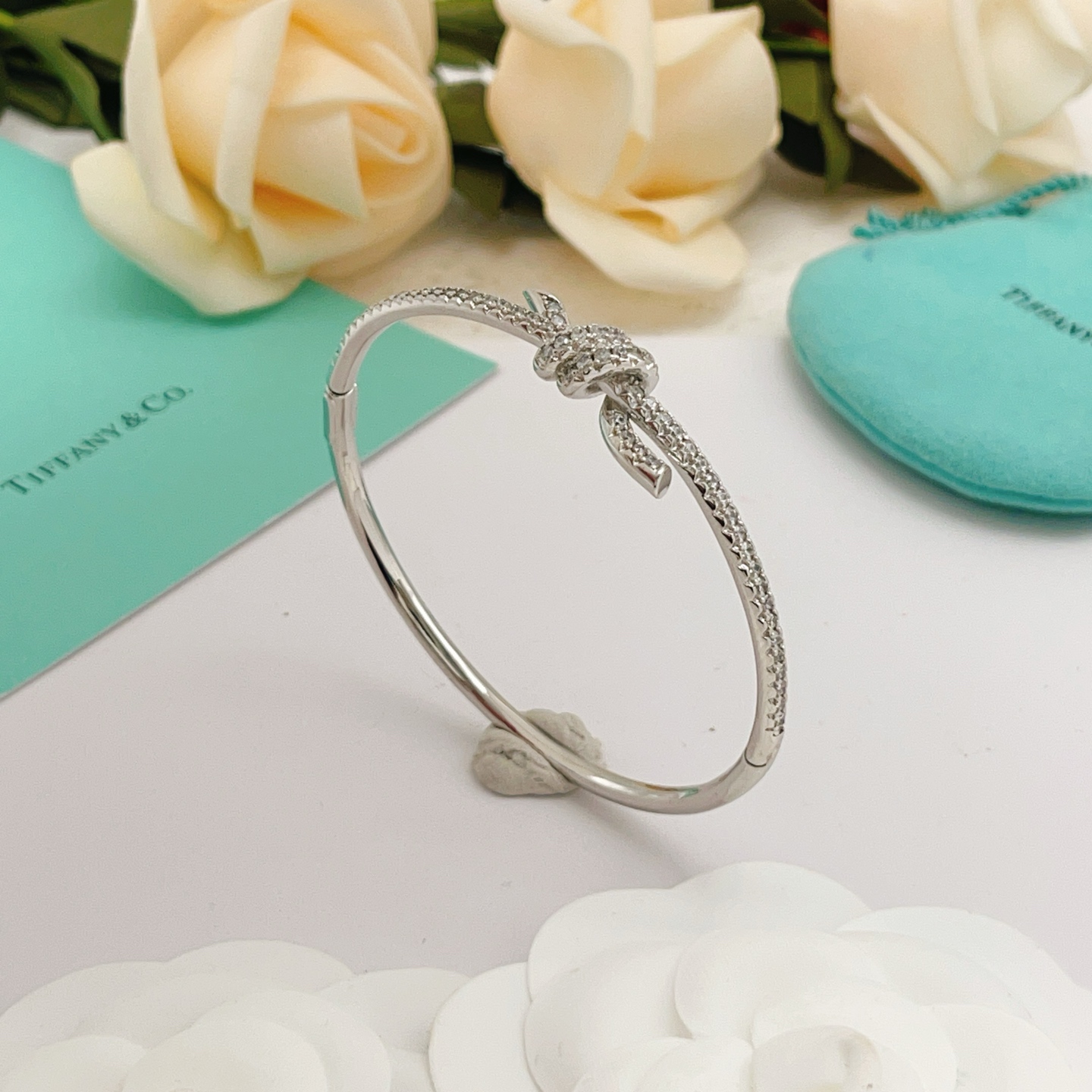 Tiffany Co Knot bracelet silver-toned metal with clear diamond accents 17cm inner circumference