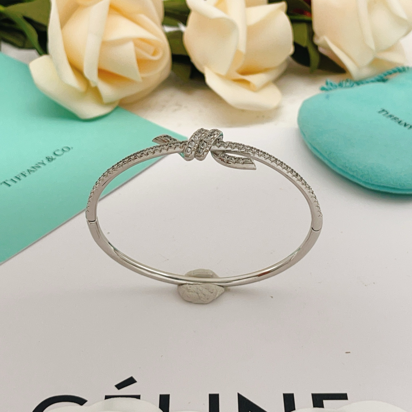 Tiffany Co Knot bracelet silver-toned metal with clear diamond accents 17cm inner circumference