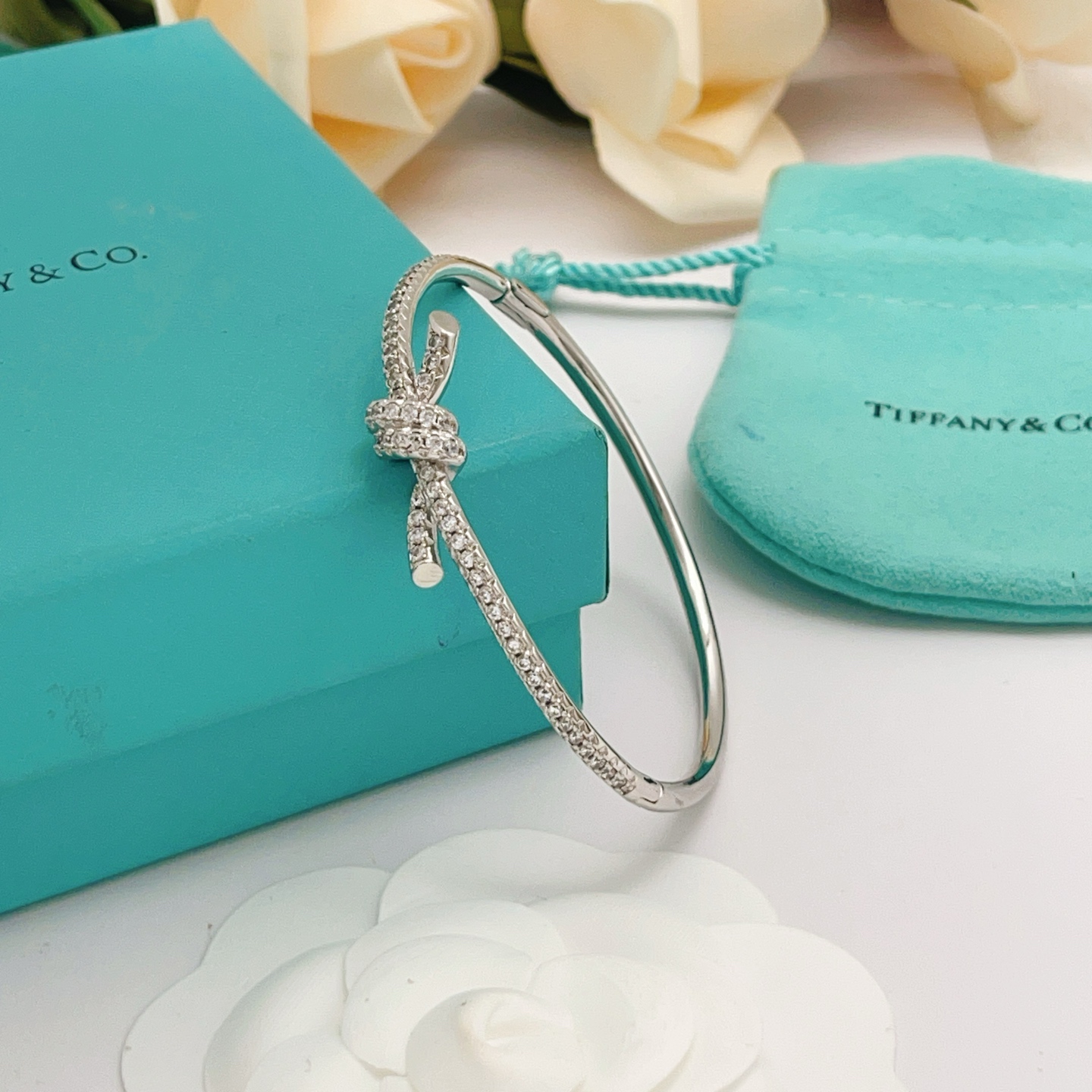 Tiffany Co Knot bracelet silver-toned metal with clear diamond accents 17cm inner circumference