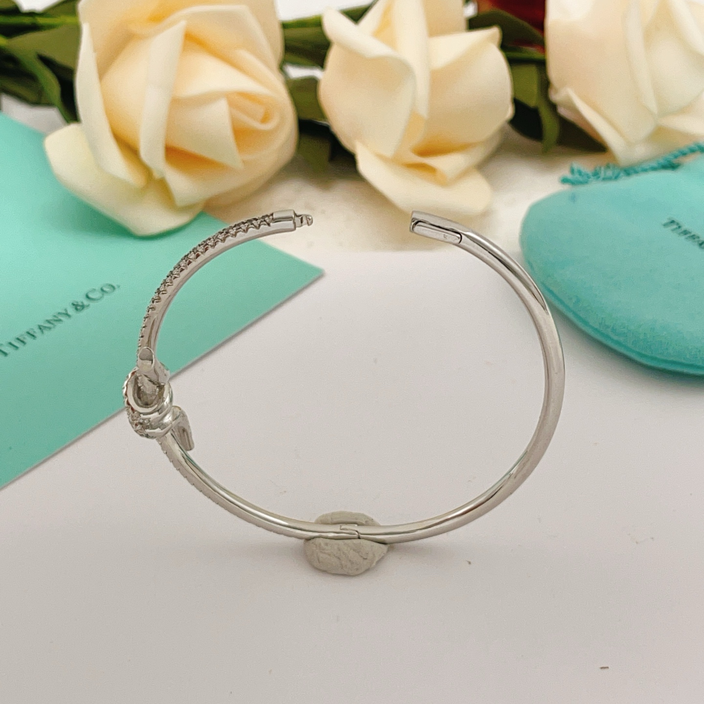 Tiffany Co Knot bracelet silver-toned metal with clear diamond accents 17cm inner circumference