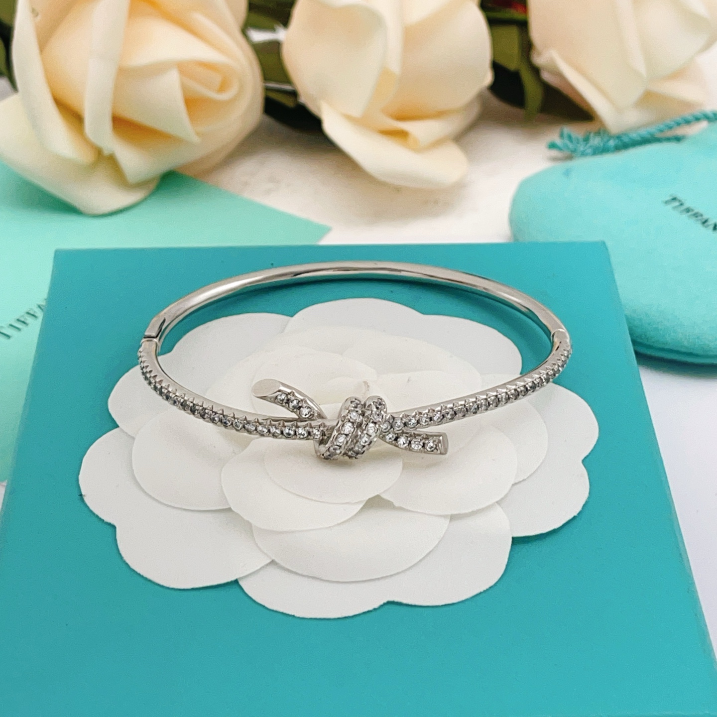 Tiffany Co Knot bracelet silver-toned metal with clear diamond accents 17cm inner circumference