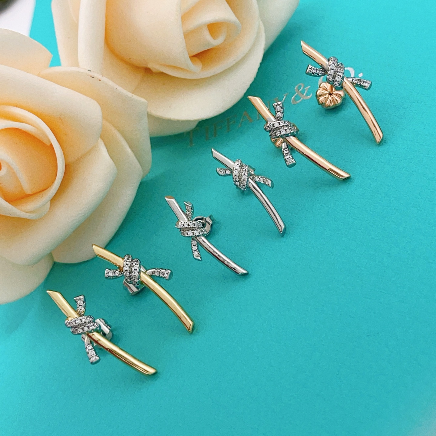 Tiffany Co Knot earrings yellow gold metal with white gold diamond-accented knot clear diamond stones 15mm length