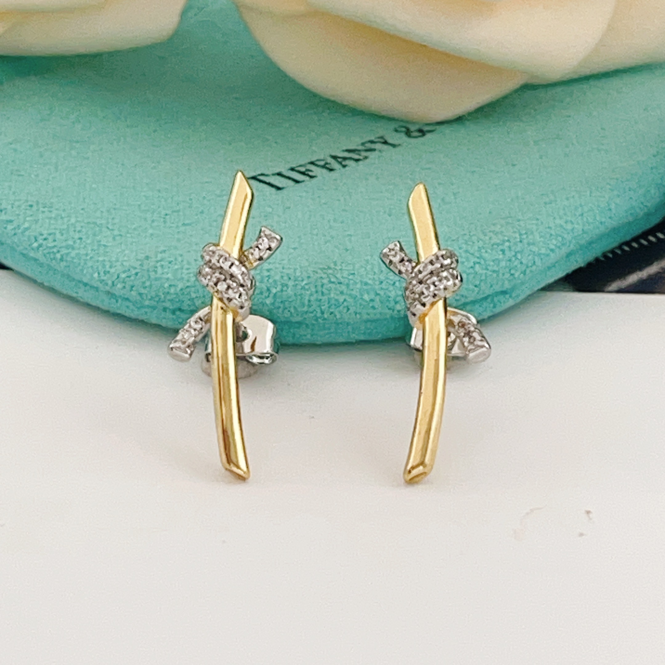 Tiffany Co Knot earrings yellow gold metal with white gold diamond-accented knot clear diamond stones 15mm length