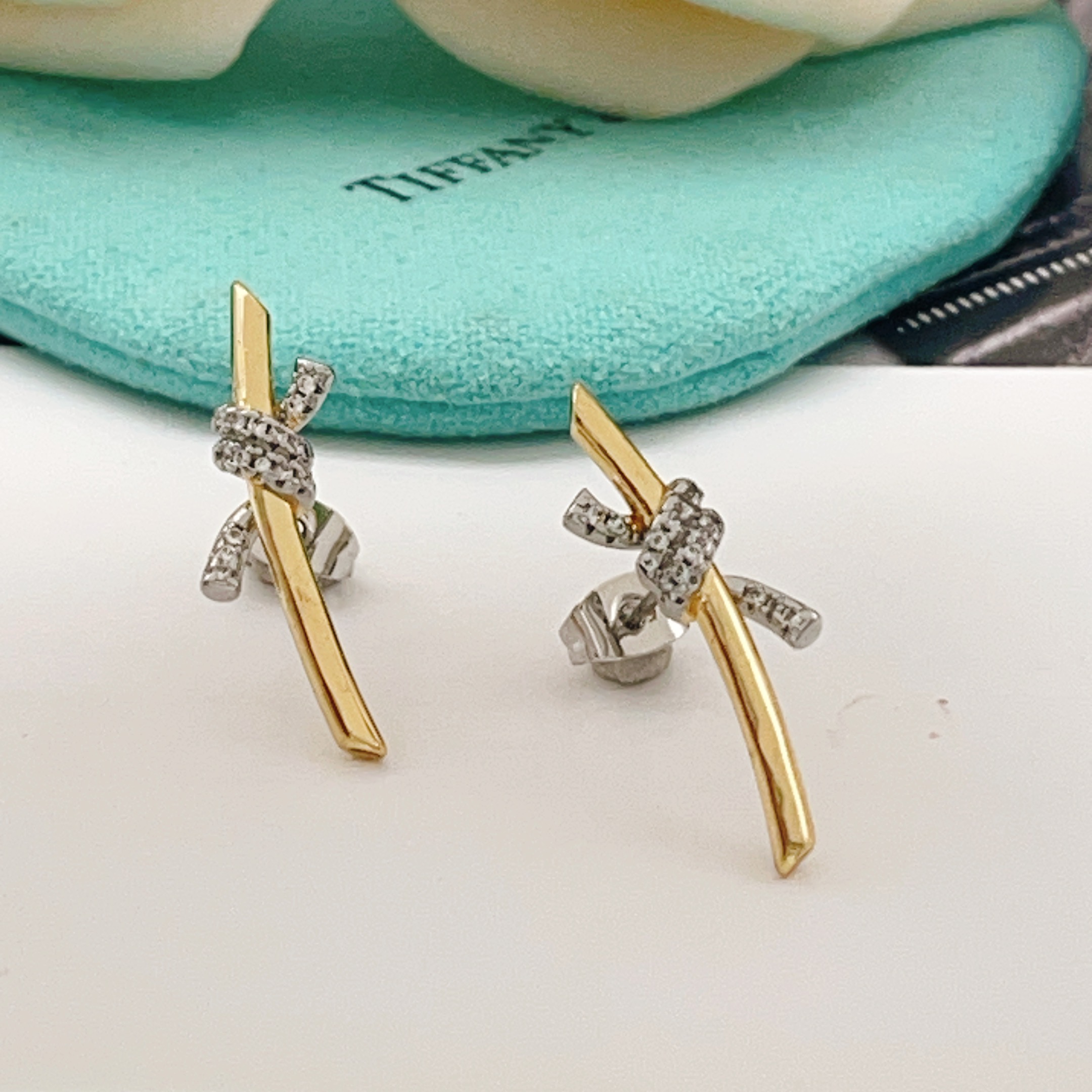 Tiffany Co Knot earrings yellow gold metal with white gold diamond-accented knot clear diamond stones 15mm length