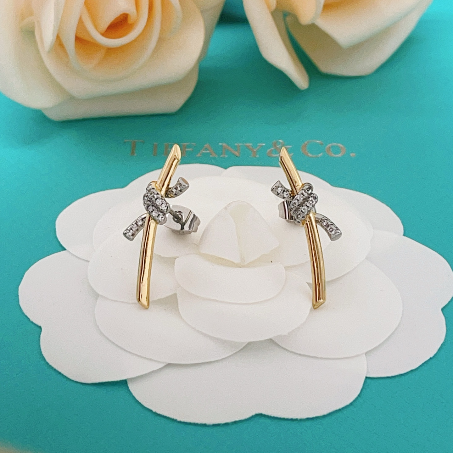 Tiffany Co Knot earrings yellow gold metal with white gold diamond-accented knot clear diamond stones 15mm length