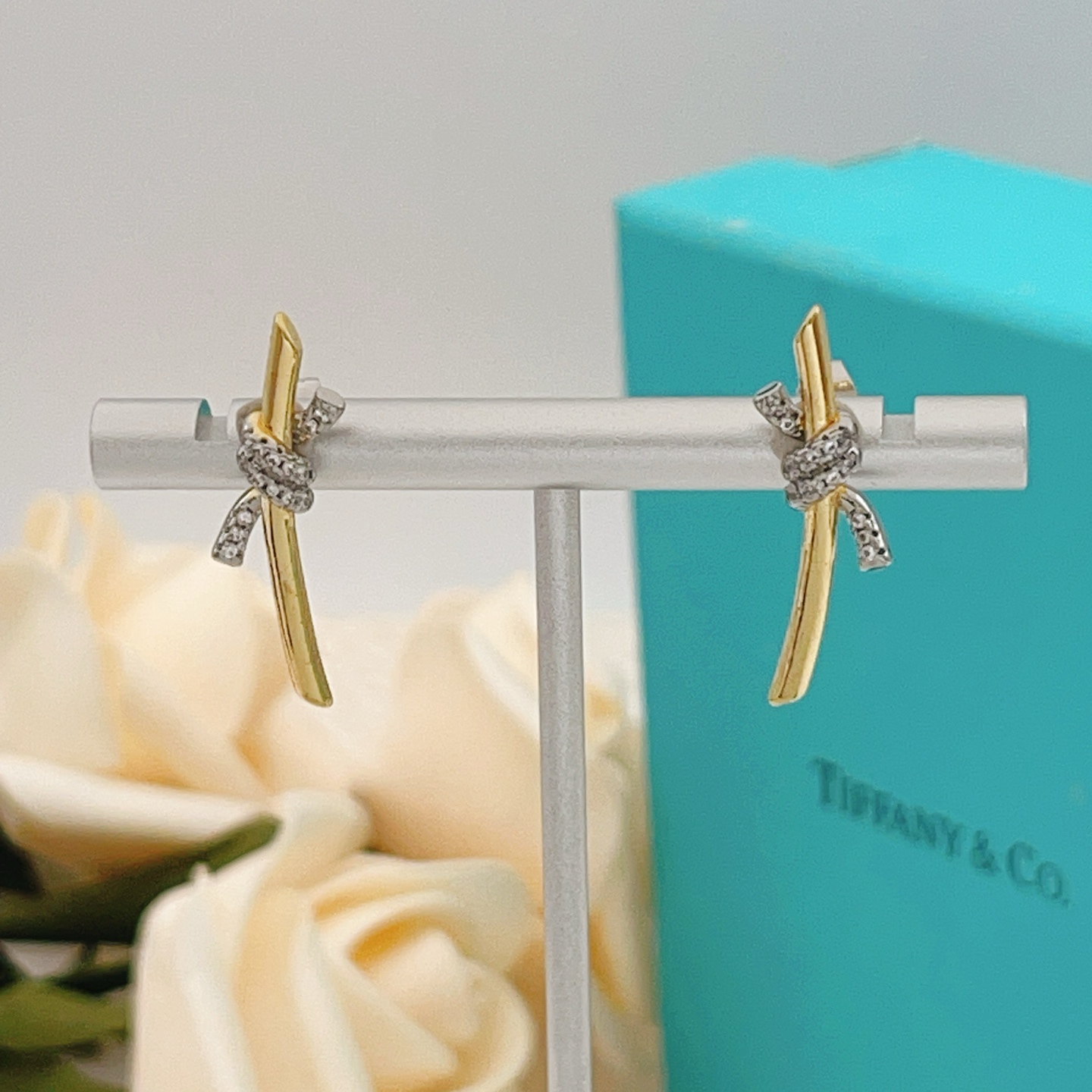 Tiffany Co Knot earrings yellow gold metal with white gold diamond-accented knot clear diamond stones 15mm length