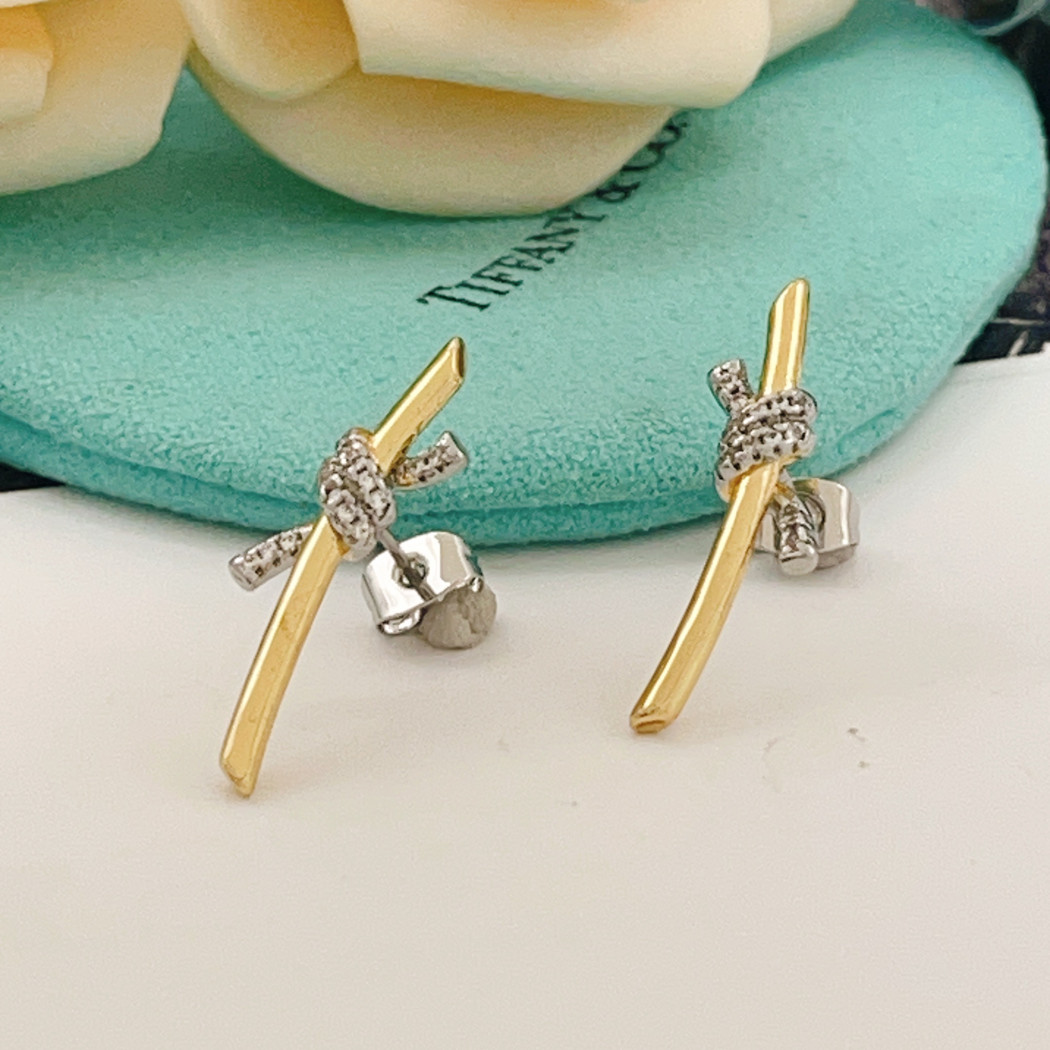 Tiffany Co Knot earrings yellow gold metal with white gold diamond-accented knot clear diamond stones 15mm length