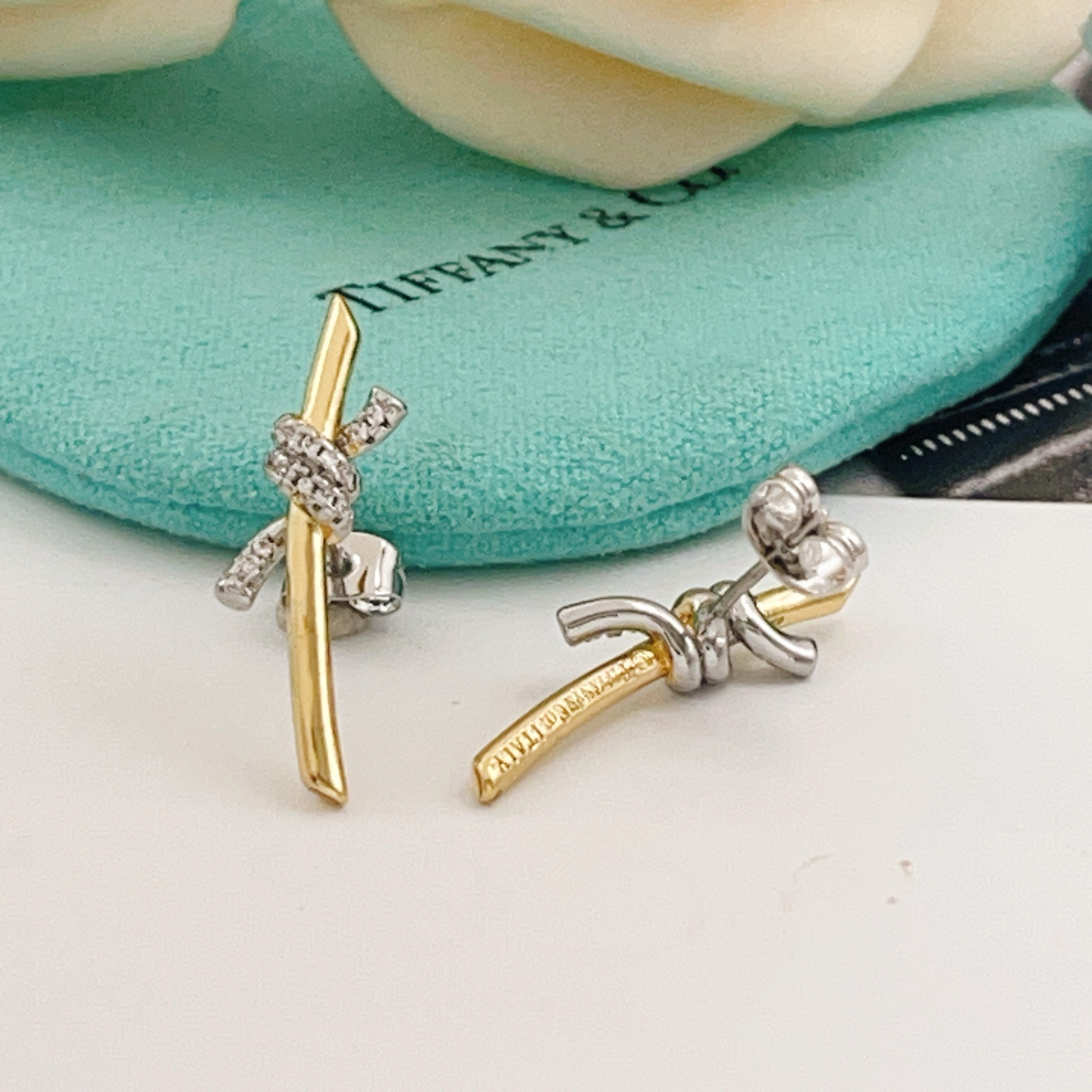 Tiffany Co Knot earrings yellow gold metal with white gold diamond-accented knot clear diamond stones 15mm length