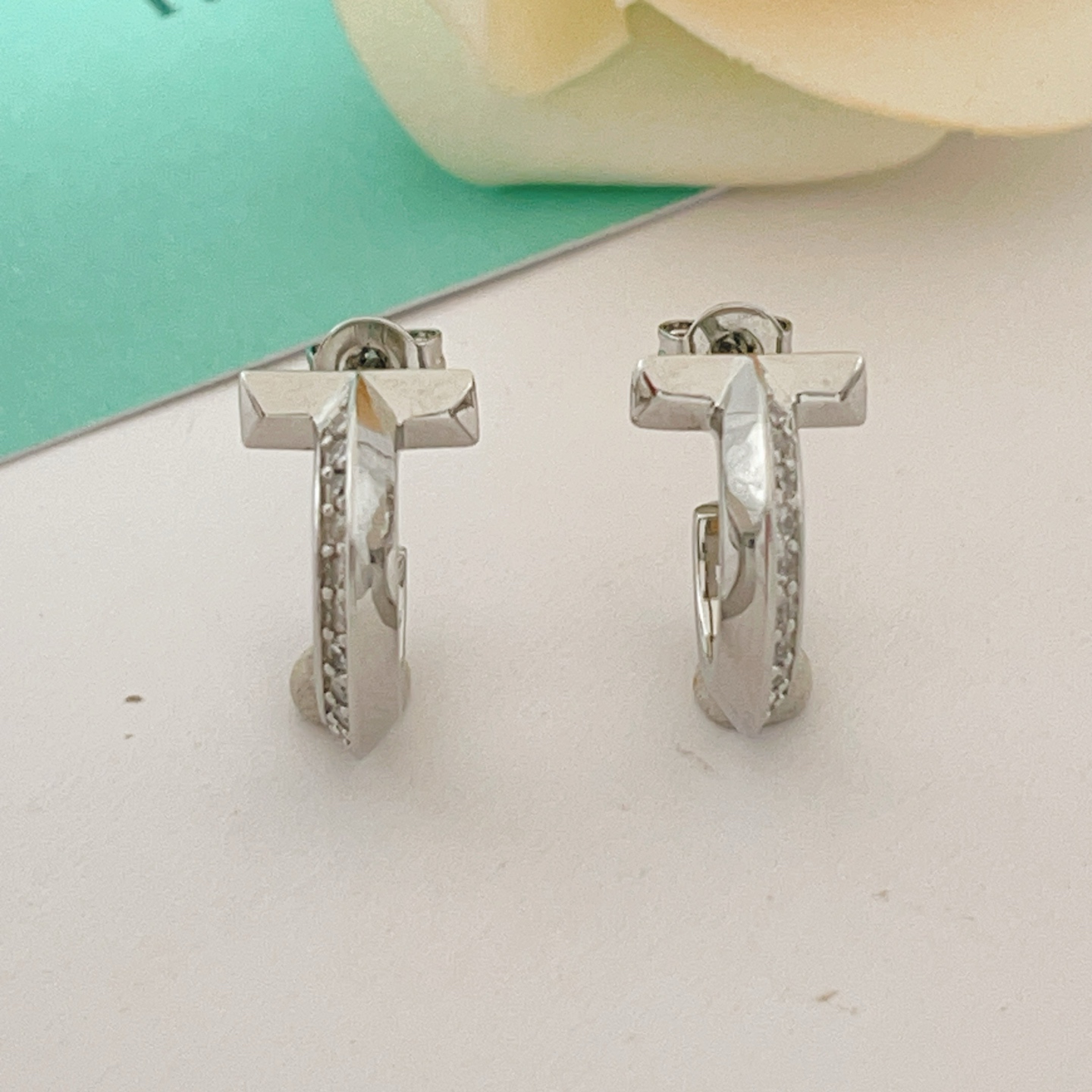 Tiffany T T1 earrings silver-toned metal with clear diamond accents 10mm hoop diameter