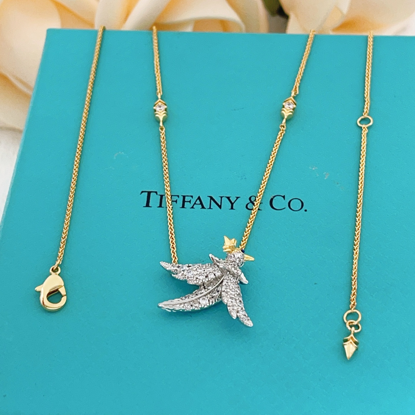 Tiffany Co Bird on a Point necklace Two-tone yellow gold and platinum-plated metal clear pave diamonds blue sapphire eye 18 inches