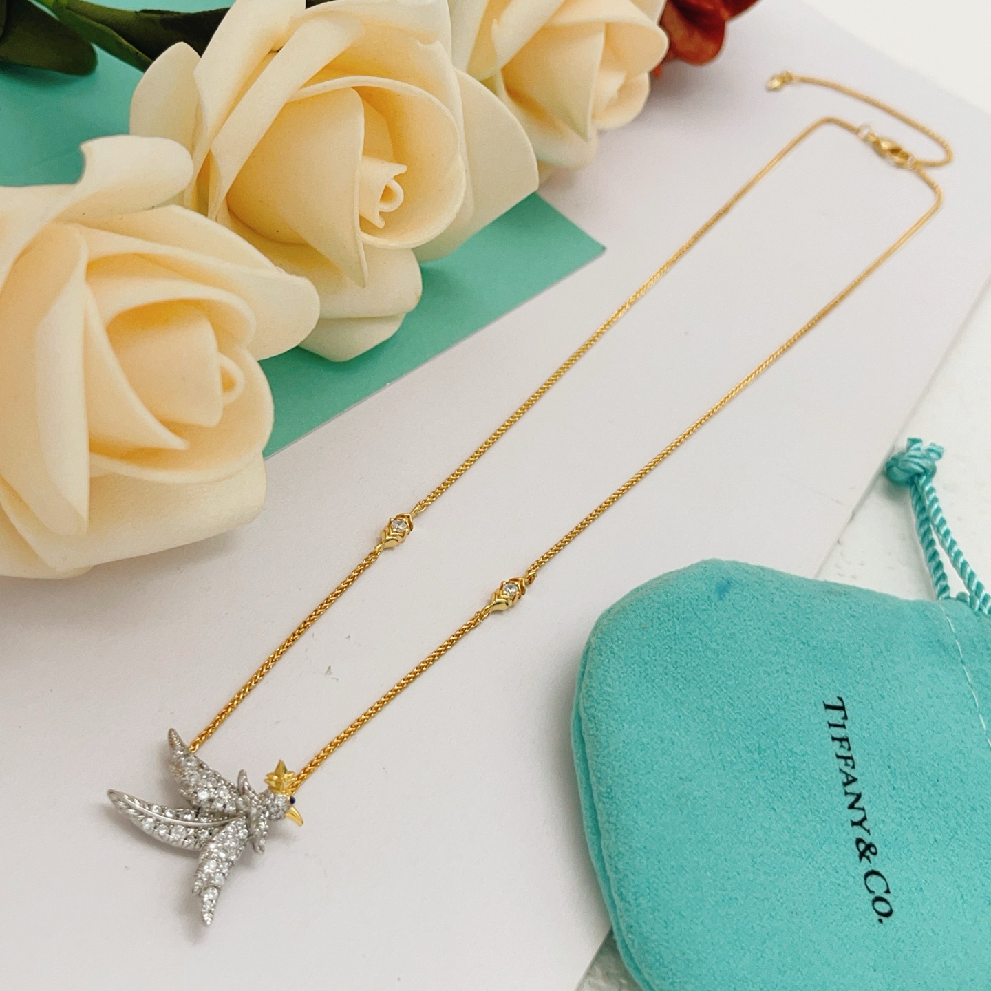 Tiffany Co Bird on a Point necklace Two-tone yellow gold and platinum-plated metal clear pave diamonds blue sapphire eye 18 inches