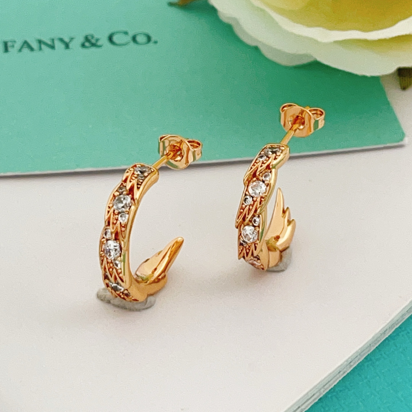 Tiffany Co Phoenix Tail Hoop Earrings earrings Gold-tone metal with clear round-cut cubic zirconia stones available in yellow gold rose gold and silver-tone metal finishes 15mm hoop diameter