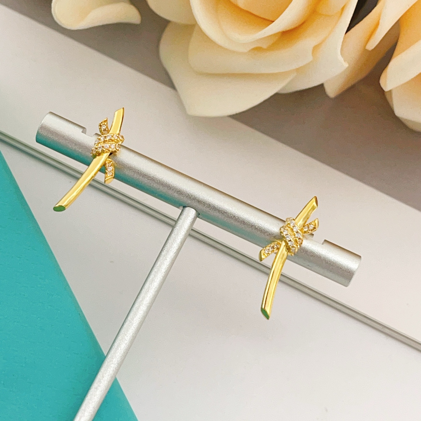 Tiffany Co Tiffany Knot earrings yellow gold with clear diamond accents 18mm bar length