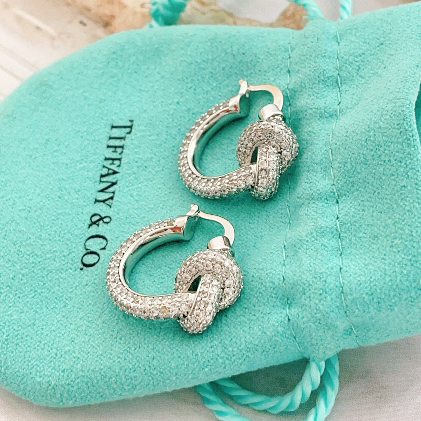 Tiffany Co Knot earrings silver-toned metal with clear pave diamonds 15mm hoop diameter