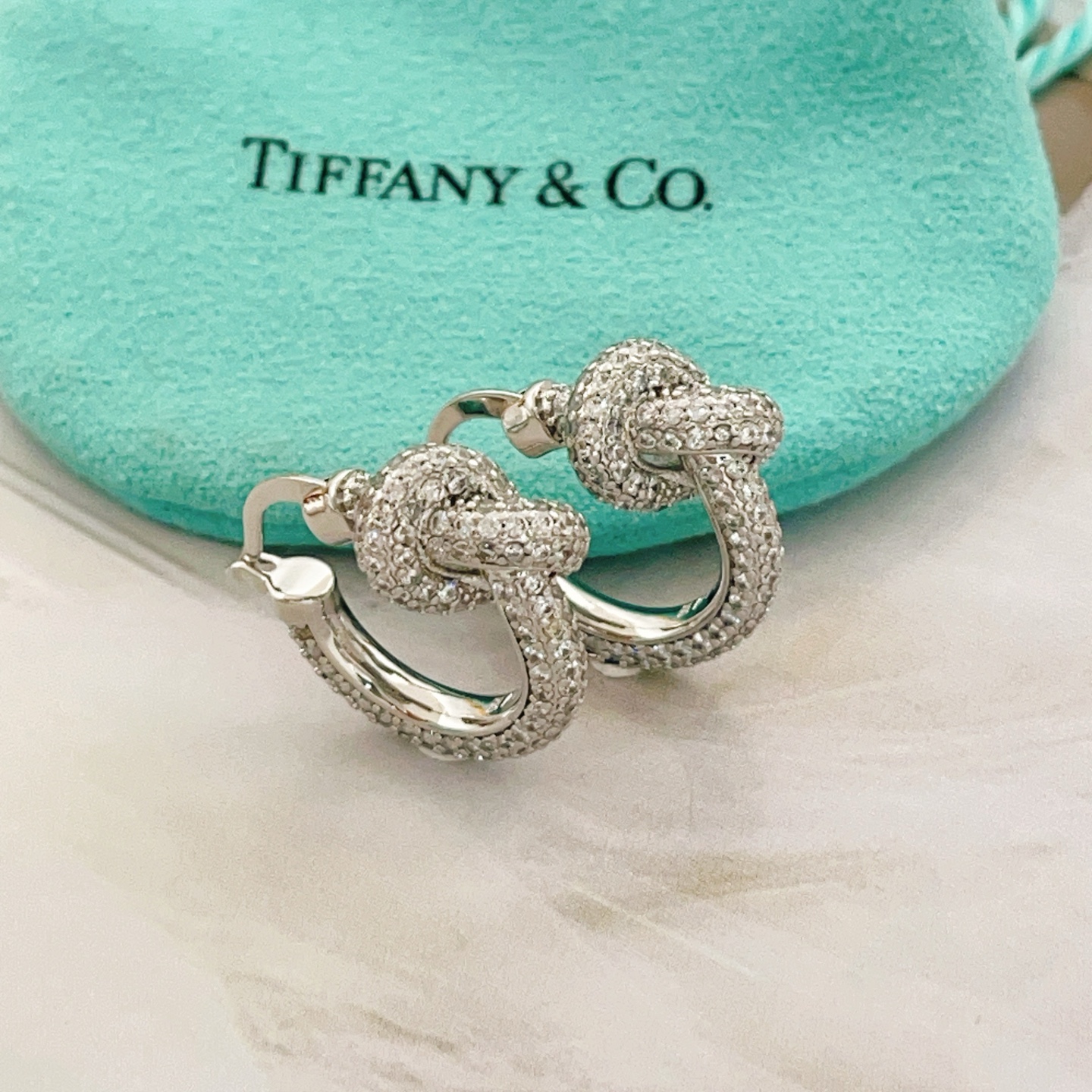 Tiffany Co Knot earrings silver-toned metal with clear pave diamonds 15mm hoop diameter