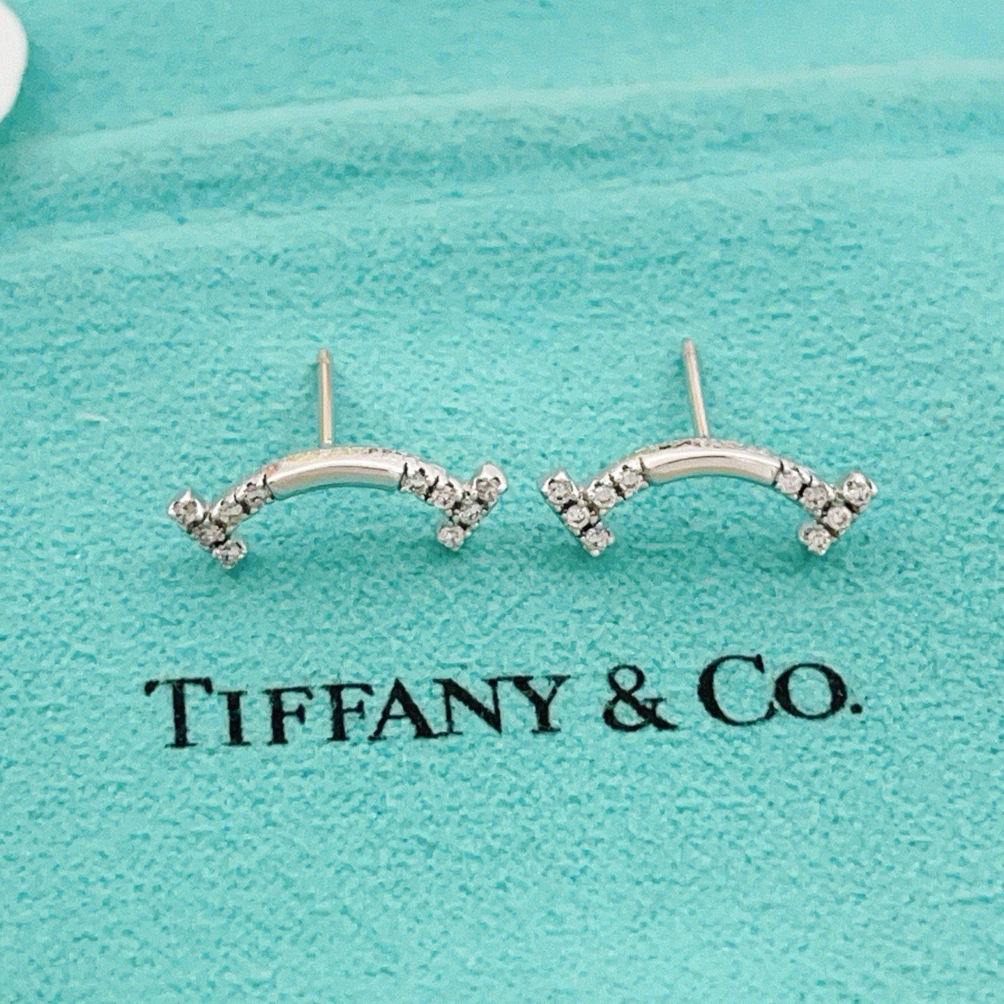 Tiffany Co T Smile earrings silver-toned white gold with clear diamond accents 12mm width