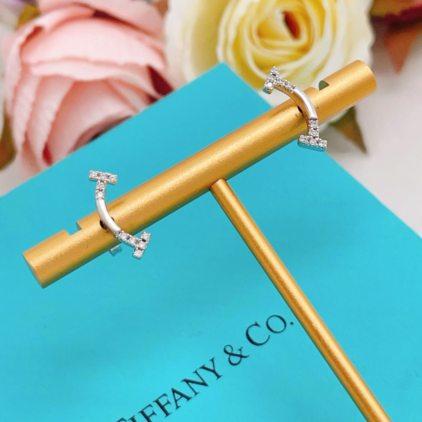 Tiffany Co T Smile earrings silver-toned white gold with clear diamond accents 12mm width