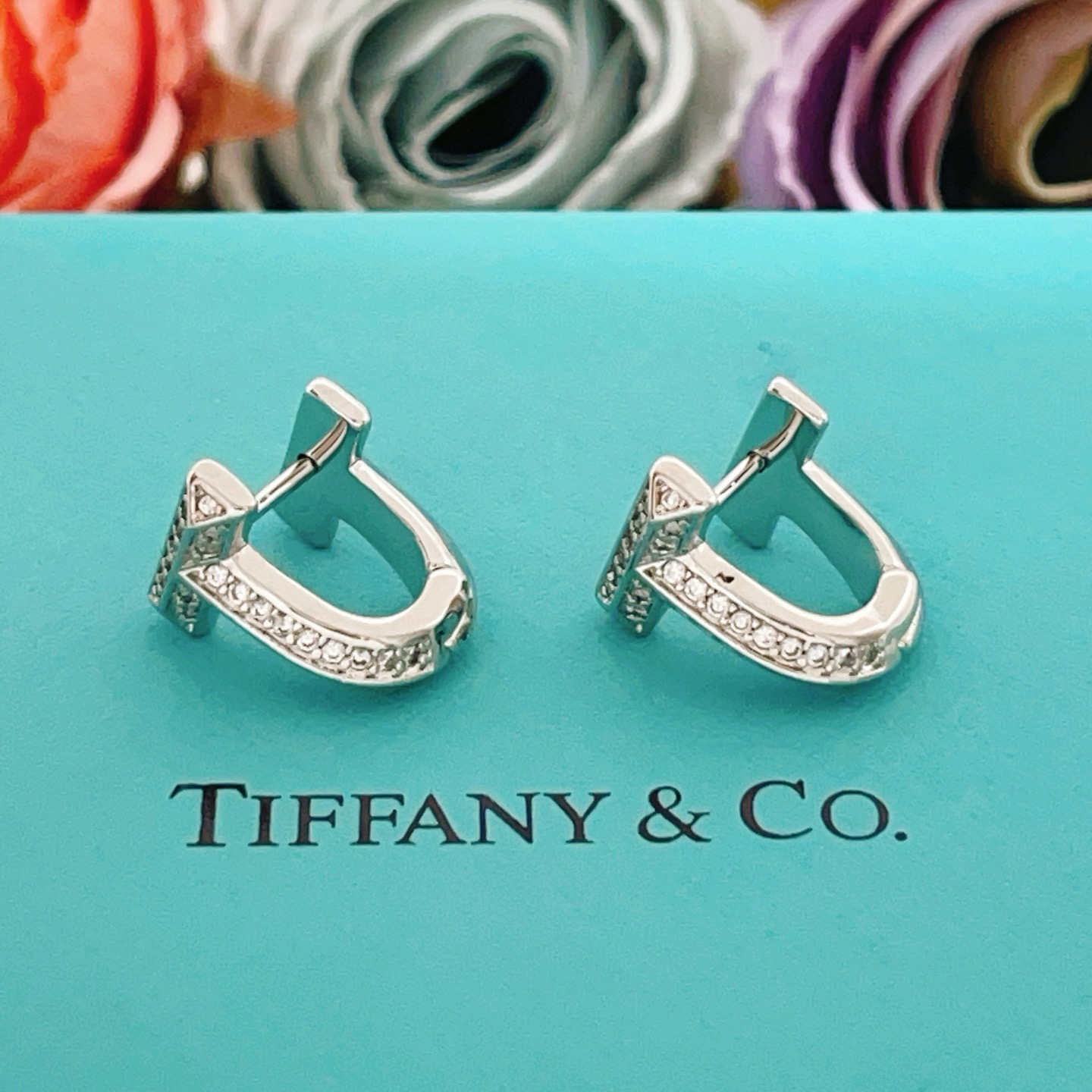 Tiffany Co Tiffany T earrings silver-toned metal with clear diamond accents 10mm