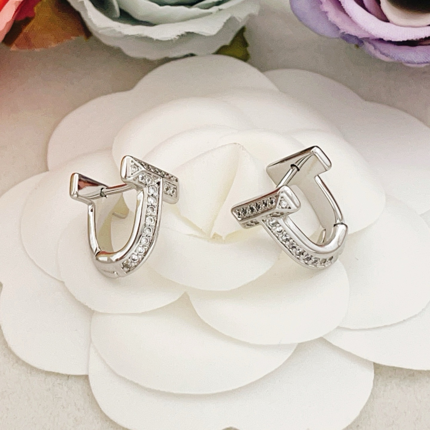 Tiffany Co Tiffany T earrings silver-toned metal with clear diamond accents 10mm
