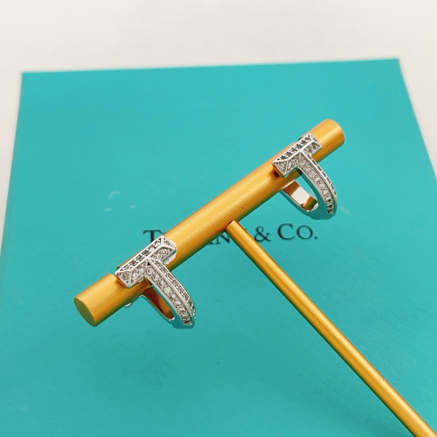 Tiffany Co Tiffany T earrings silver-toned metal with clear diamond accents 10mm