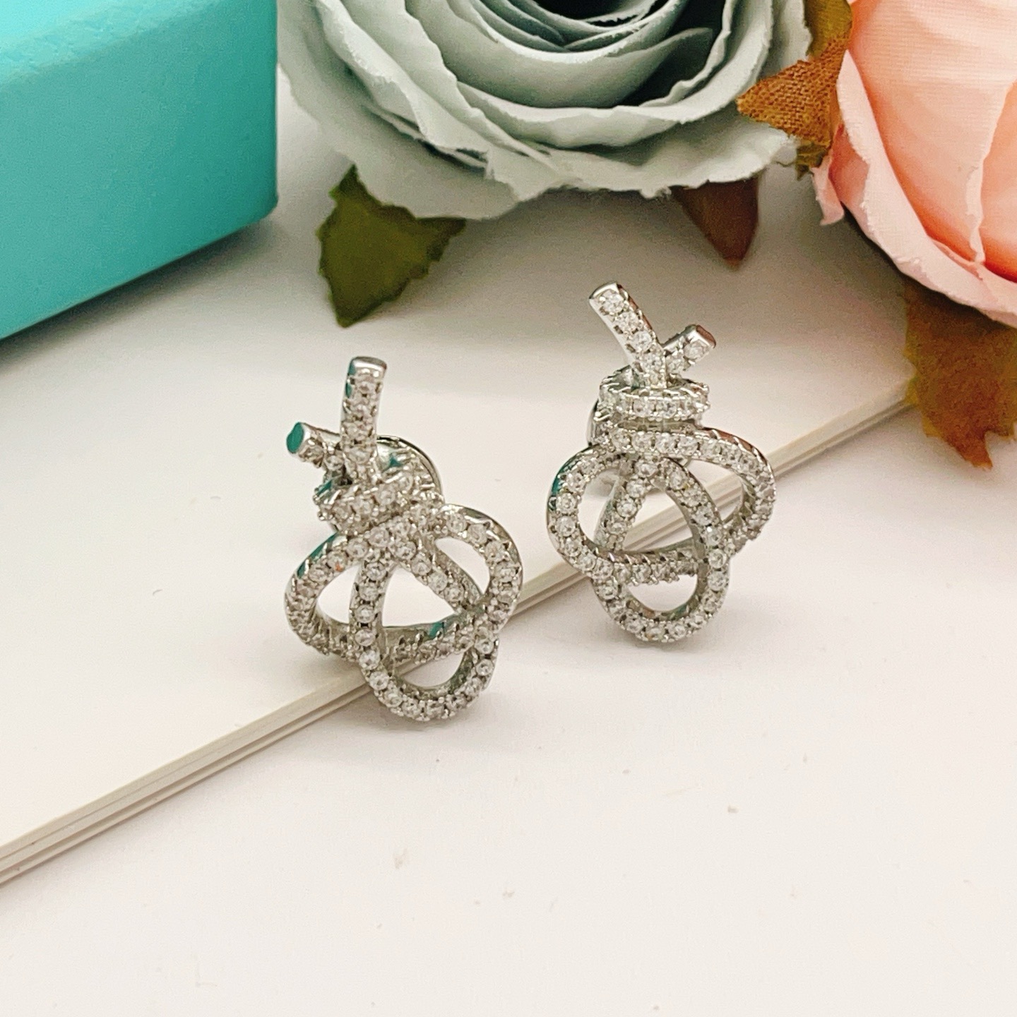 Tiffany Co Knot earrings silver-toned metal with clear diamond pave 1 5cm stud length