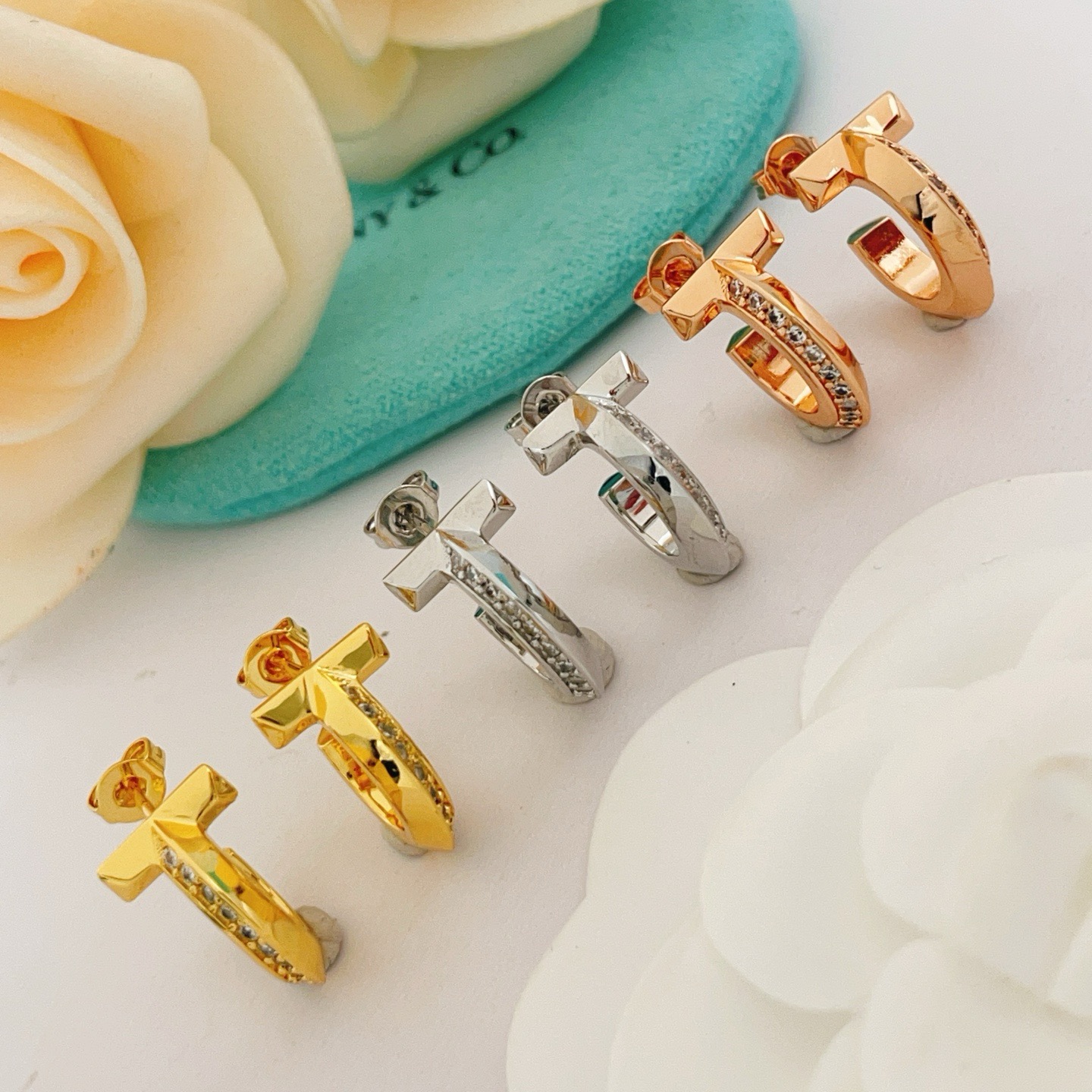 Tiffany T1 earrings rose gold metal with clear diamond accents 10mm hoop diameter