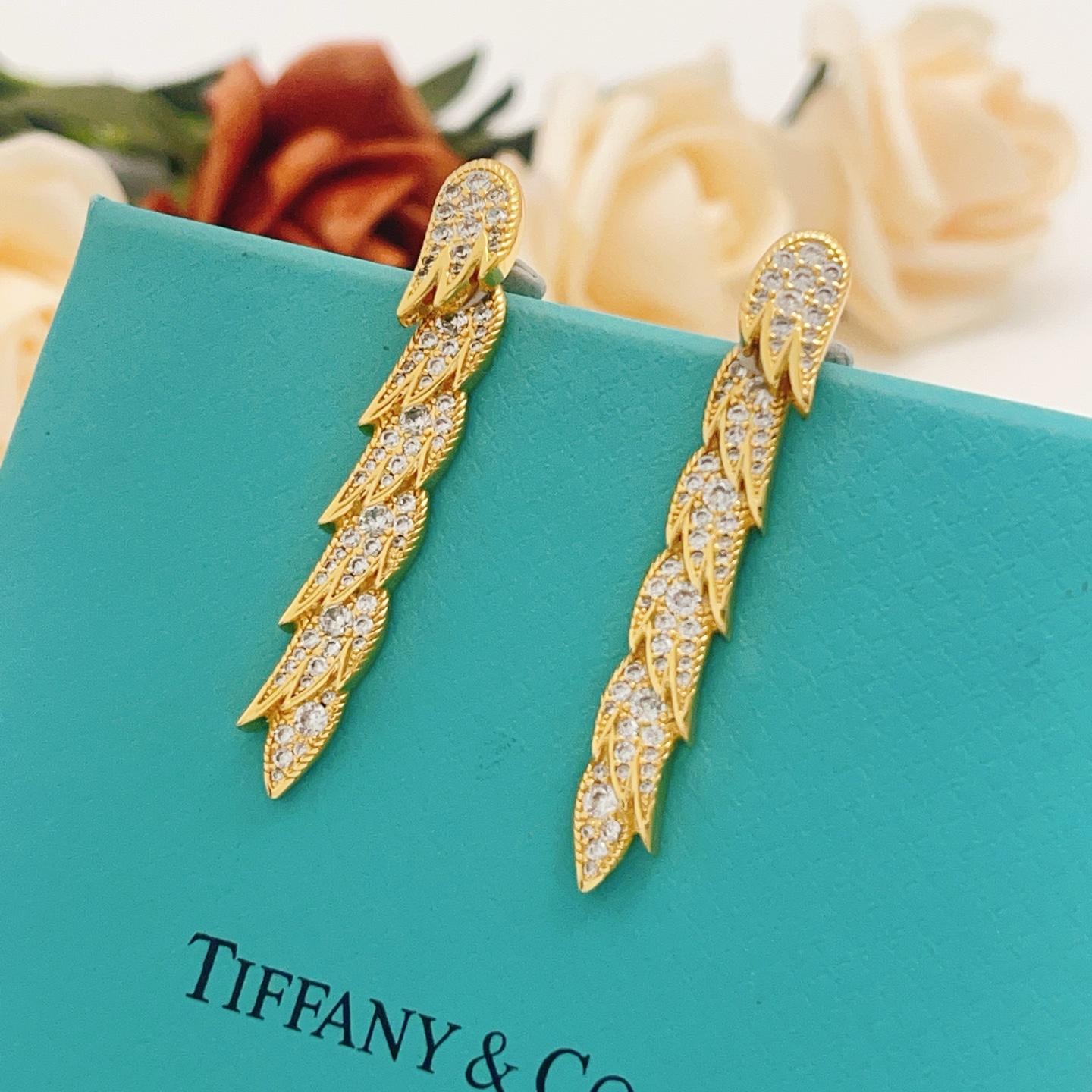 Tiffany Co Feather Drop earrings Rose gold metal with clear diamond-like gemstones 4 5cm length