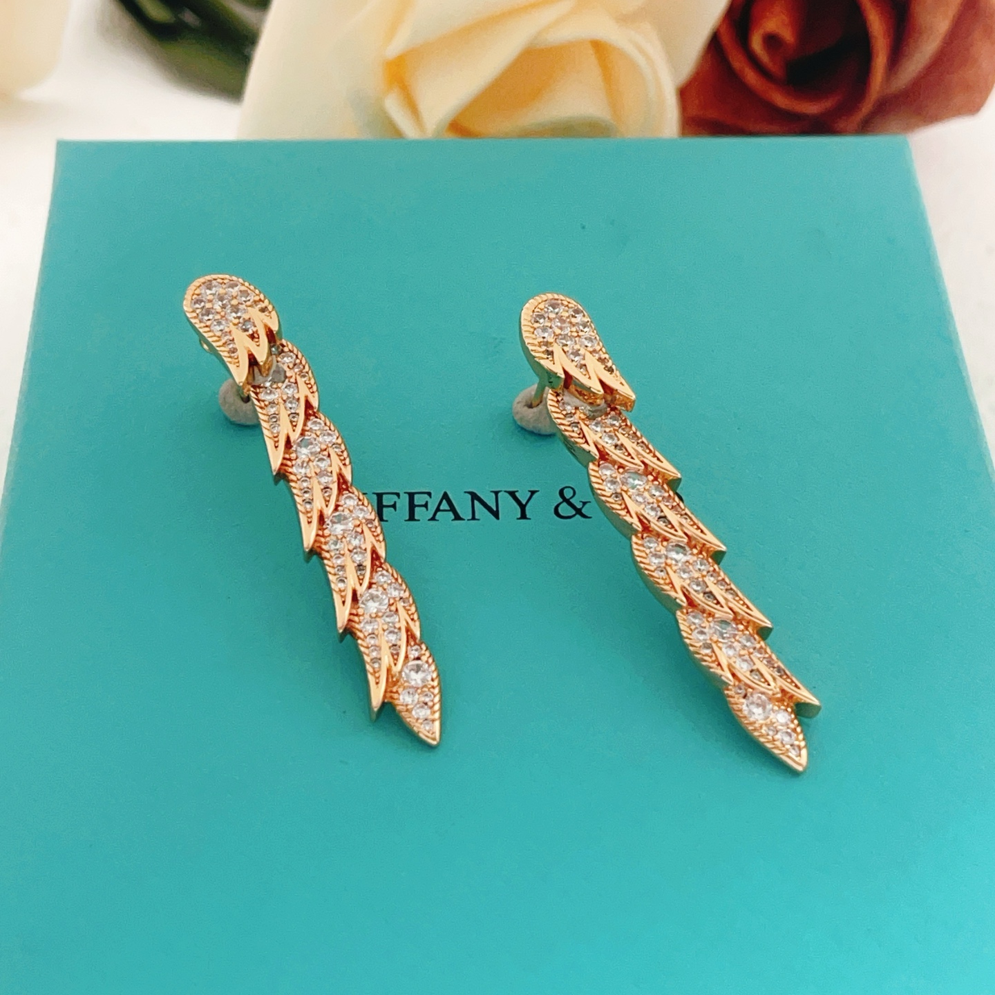 Tiffany Co Feather Drop earrings Rose gold metal with clear diamond-like gemstones 4 5cm length