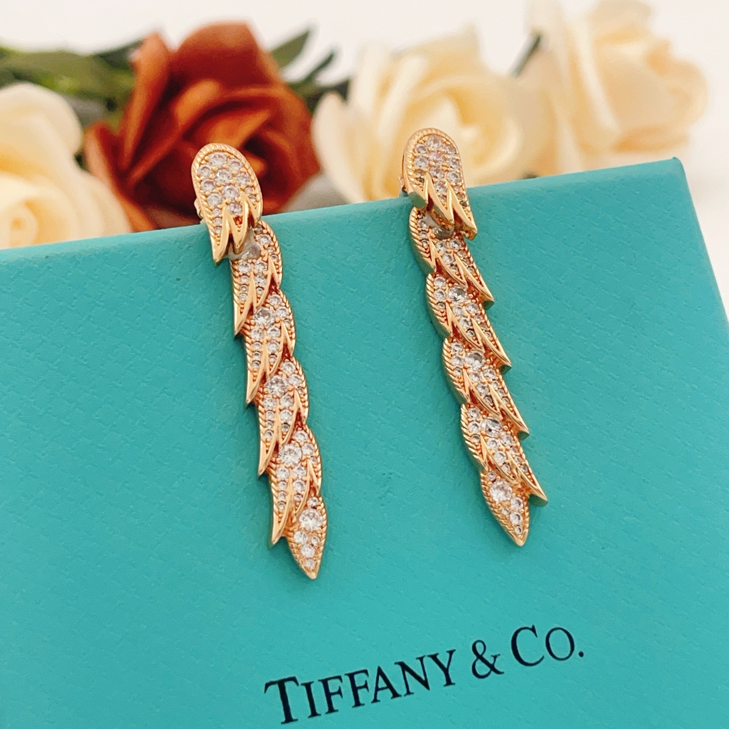 Tiffany Co Feather Drop earrings Rose gold metal with clear diamond-like gemstones 4 5cm length