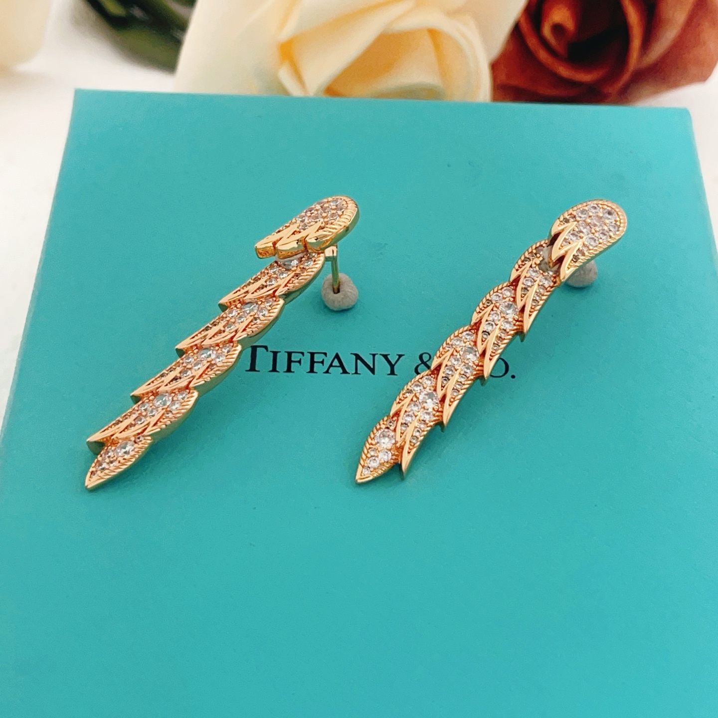 Tiffany Co Feather Drop earrings Rose gold metal with clear diamond-like gemstones 4 5cm length