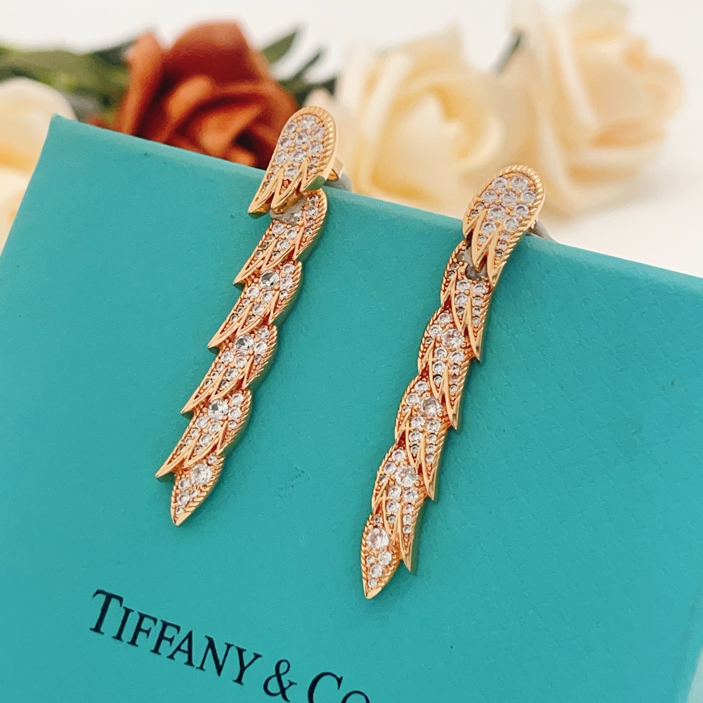 Tiffany Co Feather Drop earrings Rose gold metal with clear diamond-like gemstones 4 5cm length