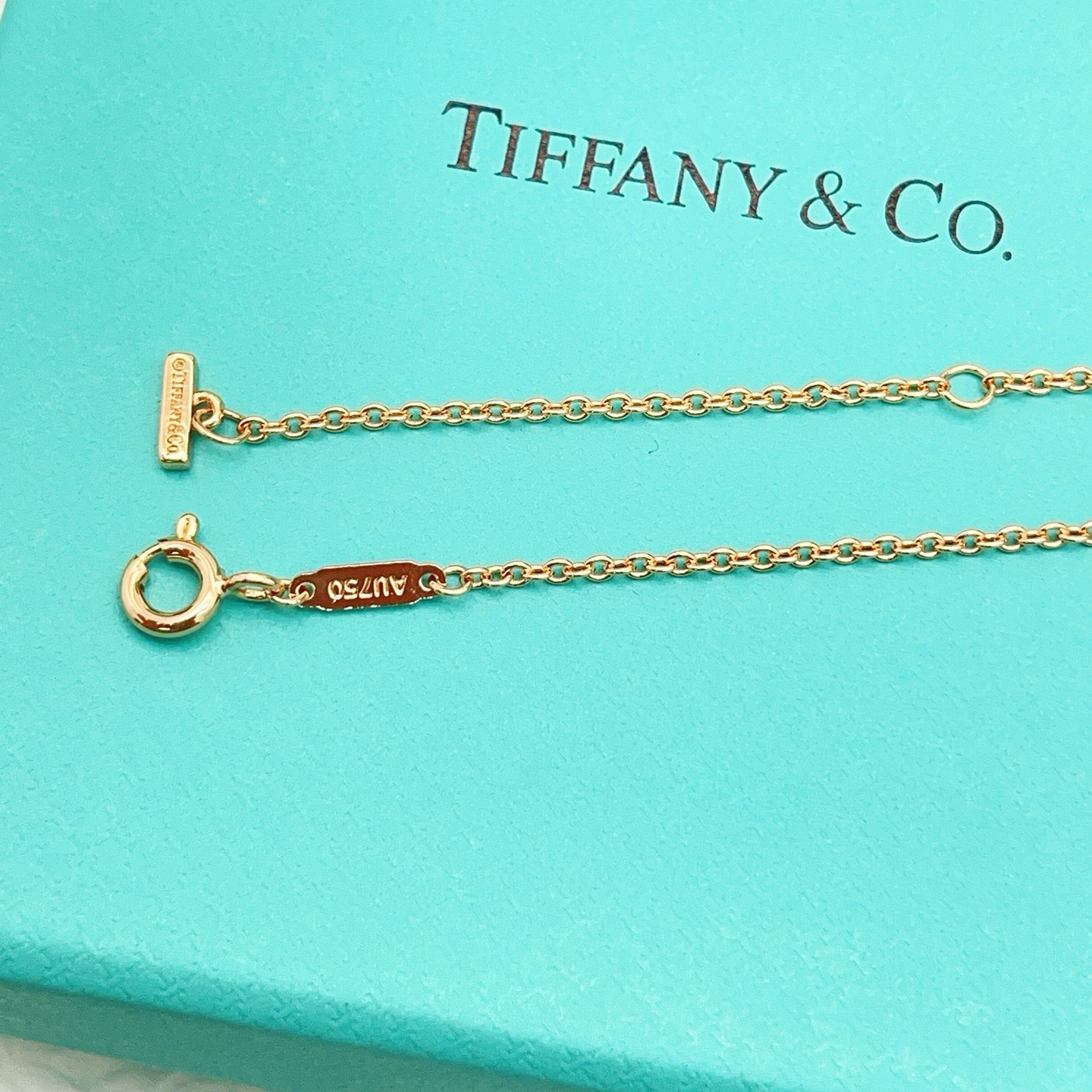 Tiffany Co T Smile necklace 18k yellow gold 18k white gold 18k rose gold with clear diamond accents 16-18 inch adjustable chain