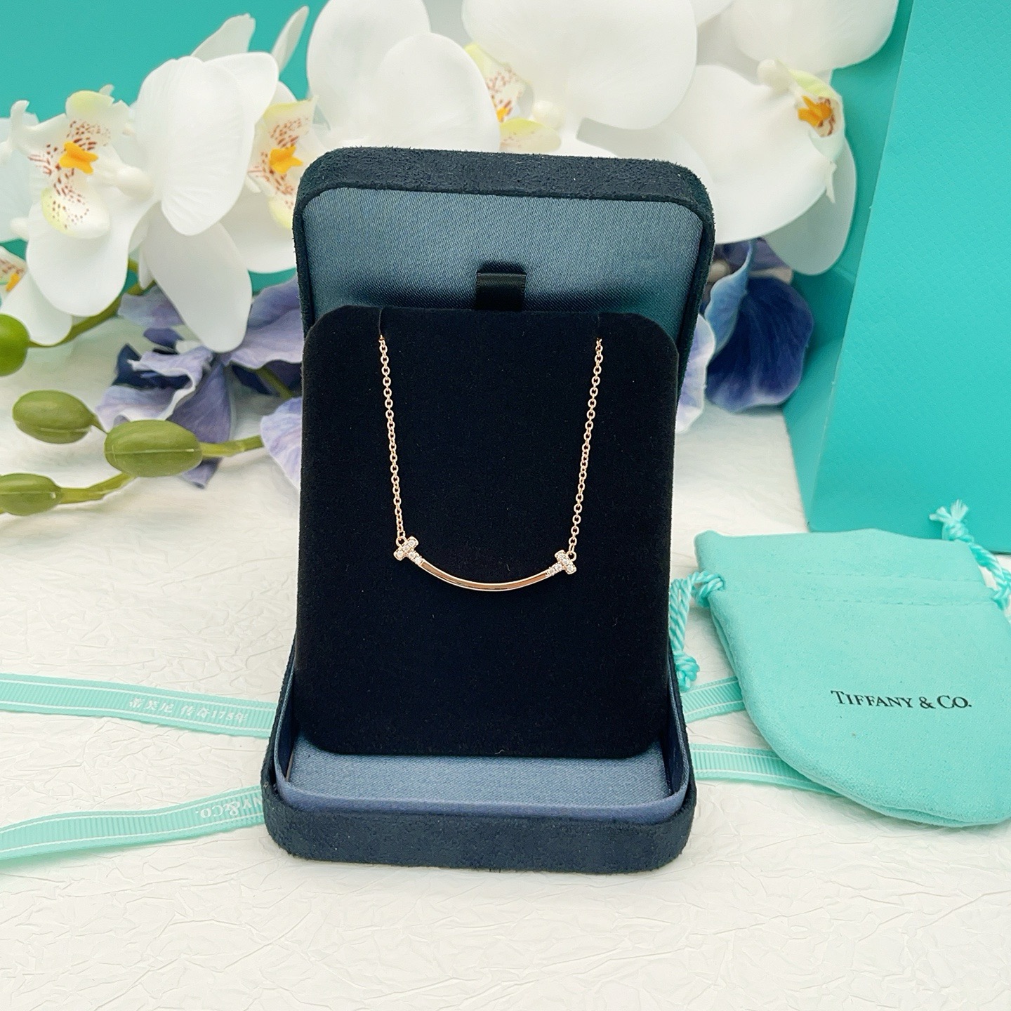 Tiffany Co T Smile necklace 18k yellow gold 18k white gold 18k rose gold with clear diamond accents 16-18 inch adjustable chain