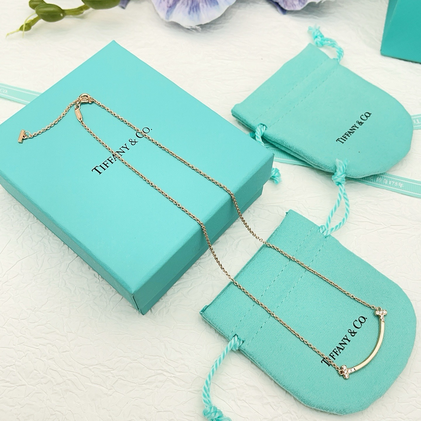Tiffany Co T Smile necklace 18k yellow gold 18k white gold 18k rose gold with clear diamond accents 16-18 inch adjustable chain