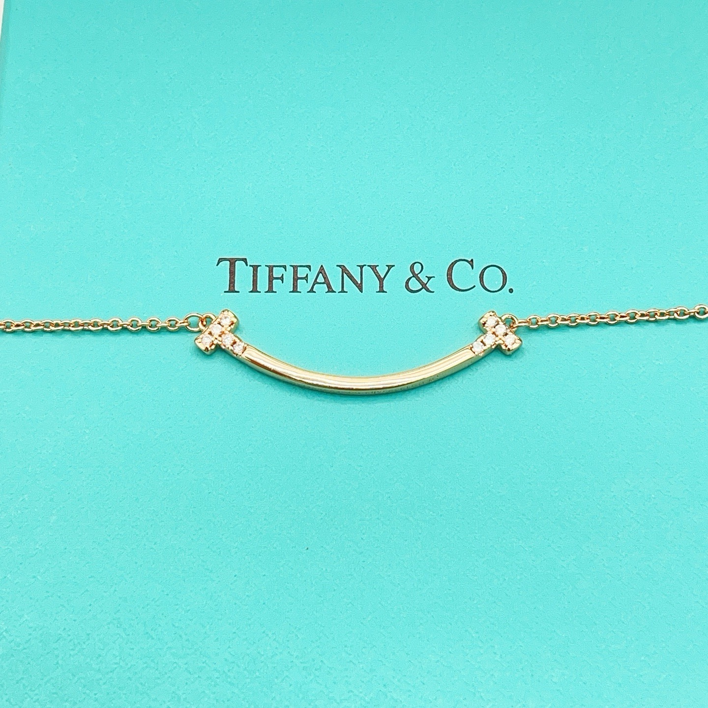 Tiffany Co T Smile necklace 18k yellow gold 18k white gold 18k rose gold with clear diamond accents 16-18 inch adjustable chain