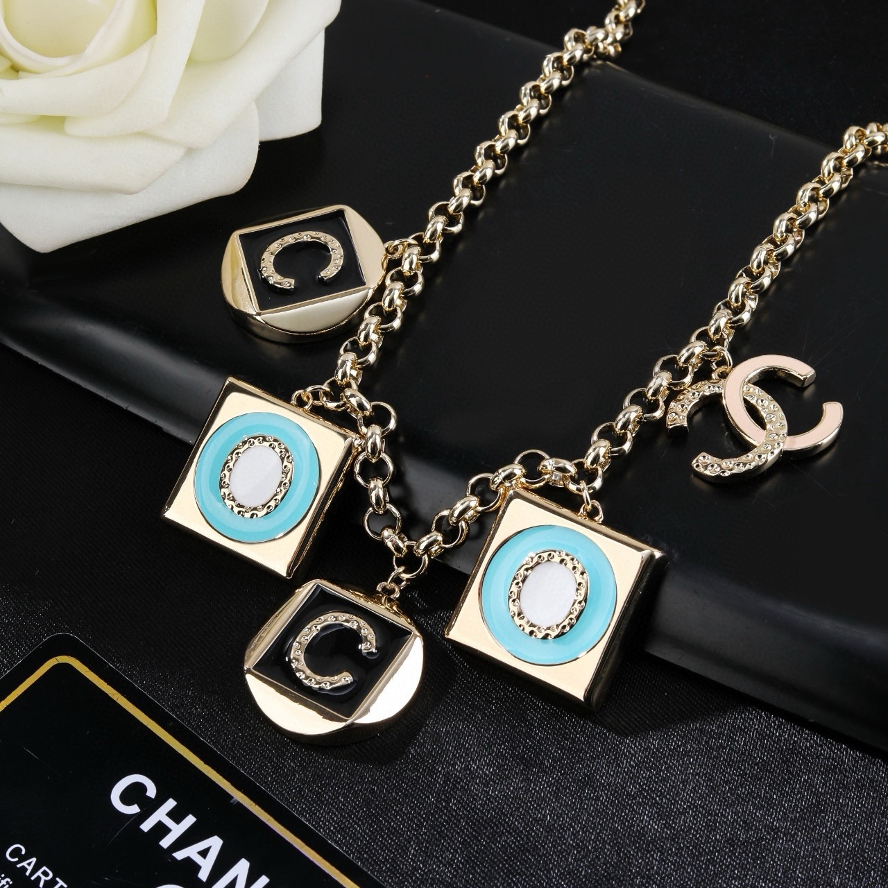 Chanel CC Logo COCO Charm Pendant Chain necklace Gold-tone metal with black enamel turquoise enamel white enamel and crystal accents 40cm with 5cm extender