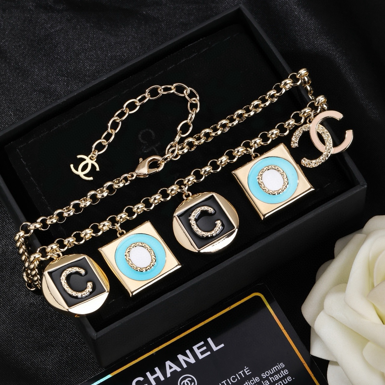 Chanel CC Logo COCO Charm Pendant Chain necklace Gold-tone metal with black enamel turquoise enamel white enamel and crystal accents 40cm with 5cm extender