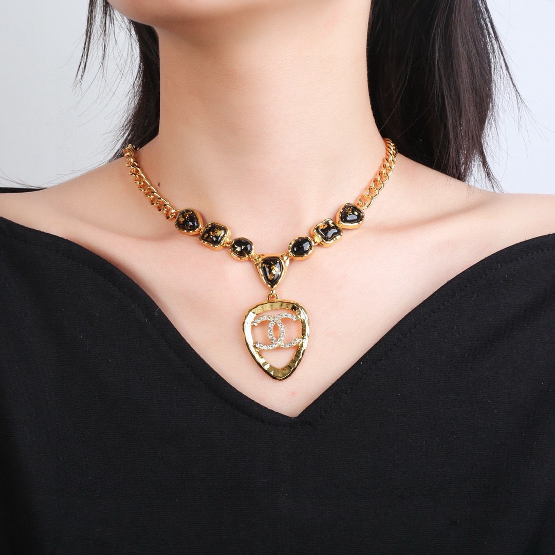 Chanel CC Logo Heart Pendant Necklace necklace Gold-tone metal with black gold-flecked resin stones and clear crystal accents 42cm with 5cm extender chain