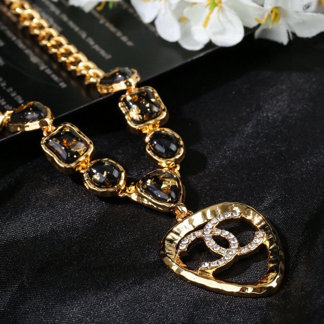 Chanel CC Logo Heart Pendant Necklace necklace Gold-tone metal with black gold-flecked resin stones and clear crystal accents 42cm with 5cm extender chain