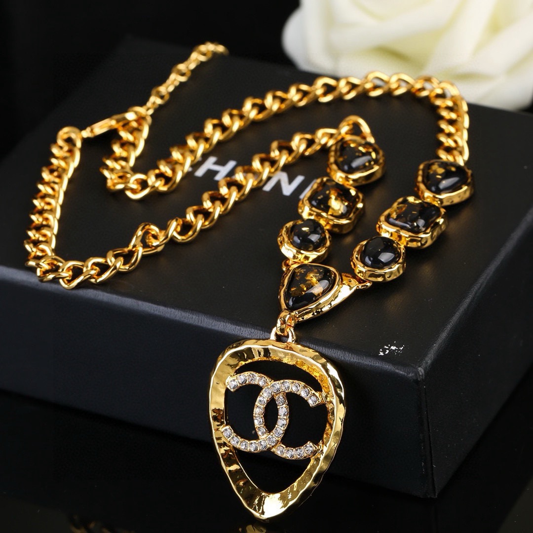 Chanel CC Logo Heart Pendant Necklace necklace Gold-tone metal with black gold-flecked resin stones and clear crystal accents 42cm with 5cm extender chain