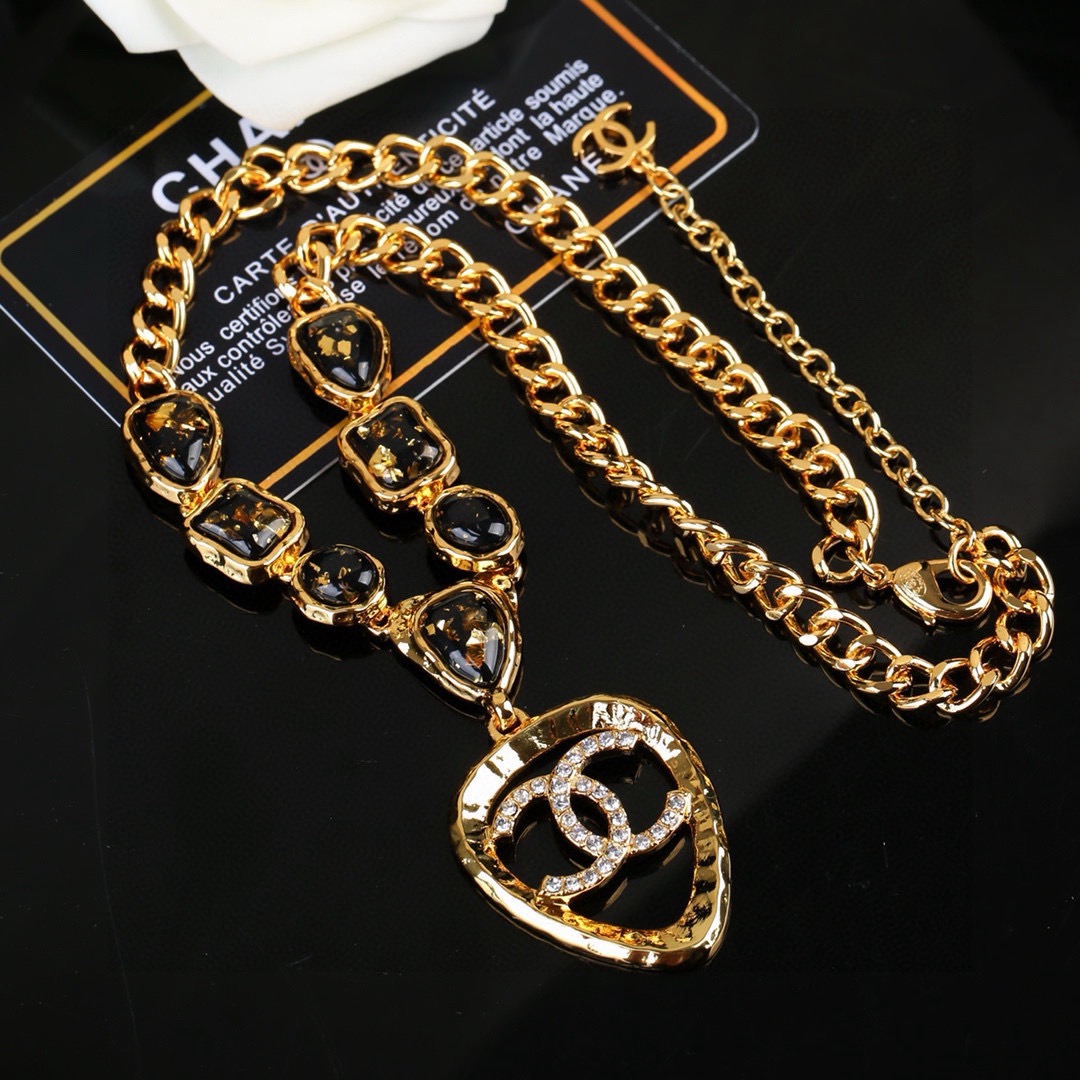 Chanel CC Logo Heart Pendant Necklace necklace Gold-tone metal with black gold-flecked resin stones and clear crystal accents 42cm with 5cm extender chain