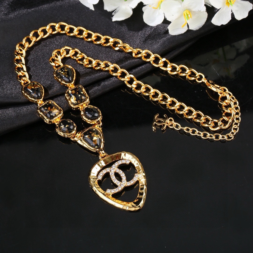 Chanel CC Logo Heart Pendant Necklace necklace Gold-tone metal with black gold-flecked resin stones and clear crystal accents 42cm with 5cm extender chain