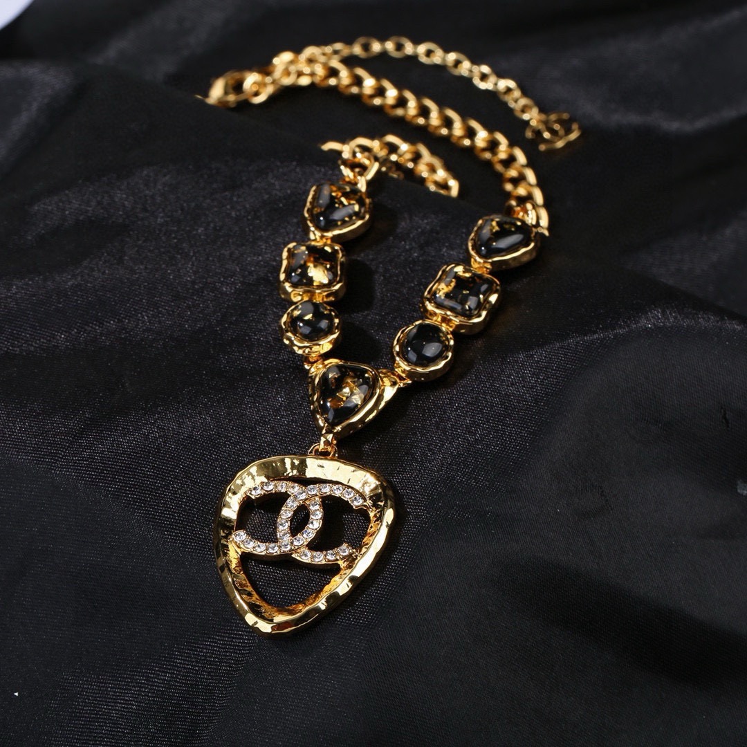 Chanel CC Logo Heart Pendant Necklace necklace Gold-tone metal with black gold-flecked resin stones and clear crystal accents 42cm with 5cm extender chain