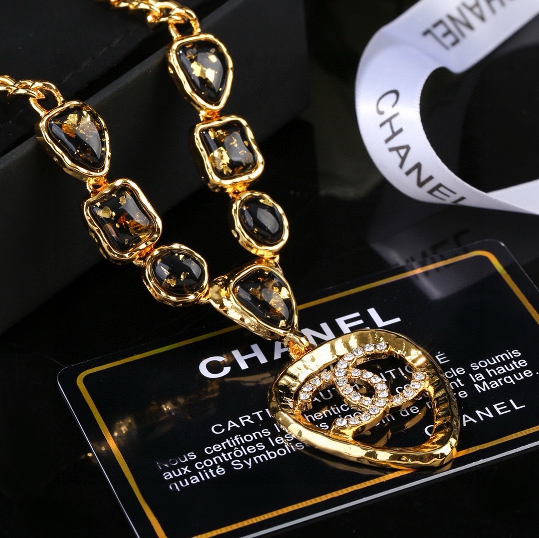 Chanel CC Logo Heart Pendant Necklace necklace Gold-tone metal with black gold-flecked resin stones and clear crystal accents 42cm with 5cm extender chain