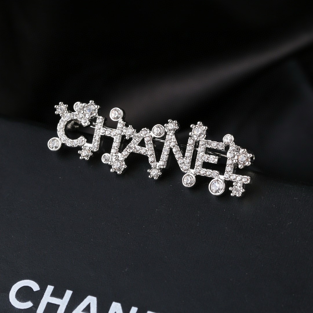 Chanel Crystal Embellished CHANEL Letter Brooch brooch silver tone metal with clear crystal accents 4 5cm width