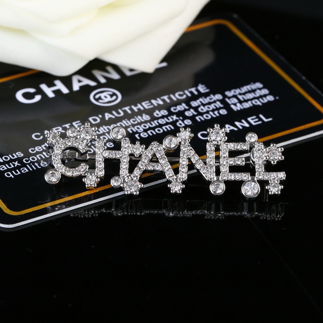 Chanel Crystal Embellished CHANEL Letter Brooch brooch silver tone metal with clear crystal accents 4 5cm width